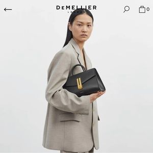 Demellier The midi Montreal black smooth leather bag.